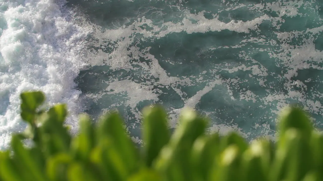 Slow motion of tropical ocean waves crashing swirling and foaming