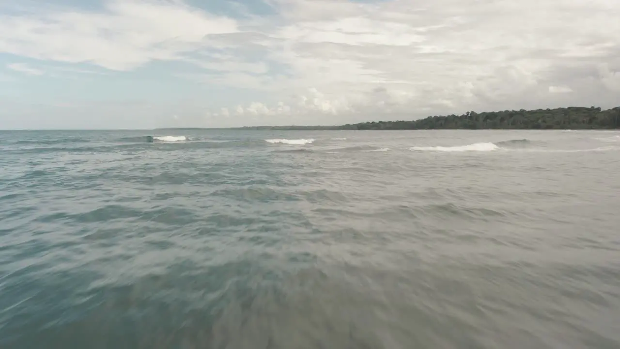 flying over the sea through a tropical island punta mona manzanillo costa Rica