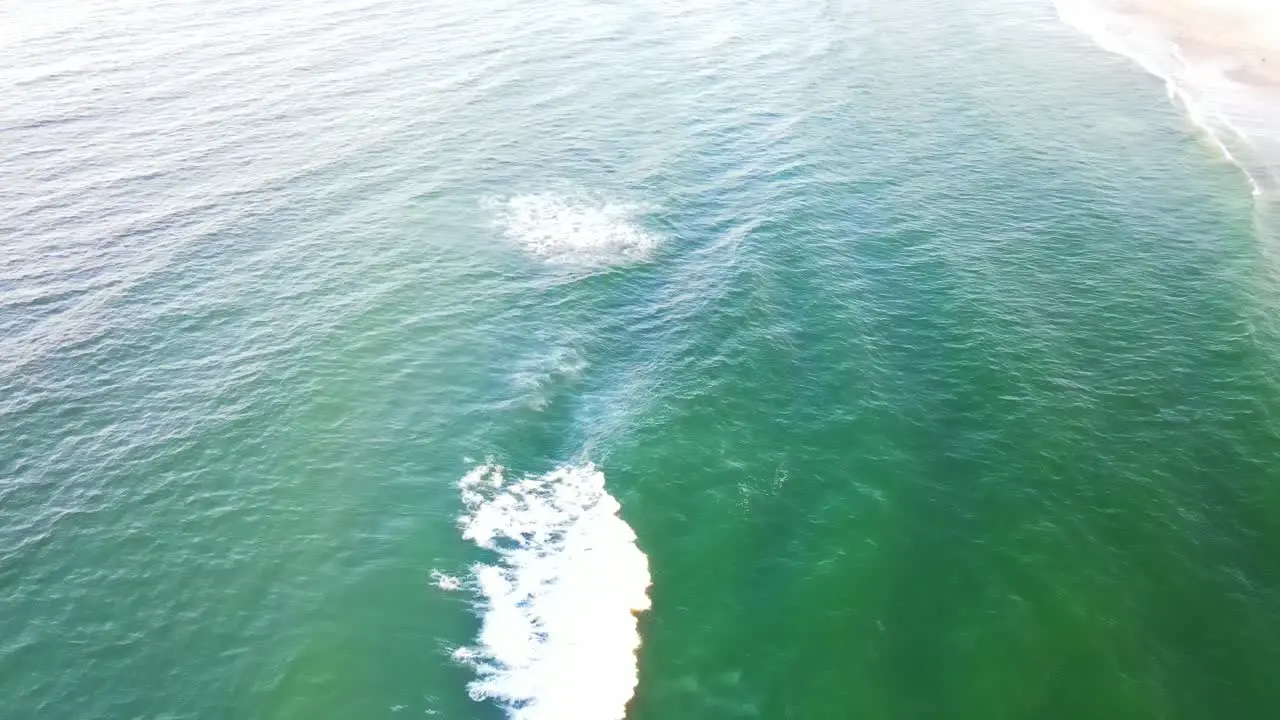 Bright Blue Ocean Rippling On A Sunny Day Touristic Beach In Gold Coast QLD Australia aerial drone slow motion