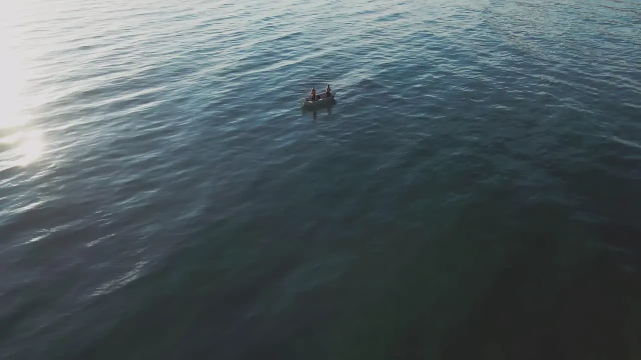 Ocean waves with a small fisherman boat floating