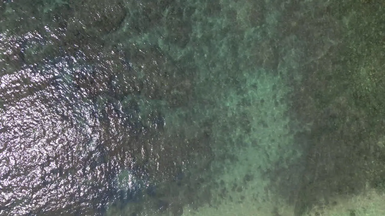 Top down view on rippled turquoise water of Pacific Ocean at Maui Island coast