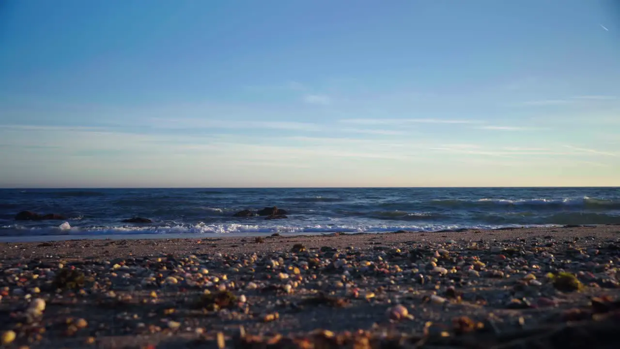 Pebbles and sand at the beach on a clear day