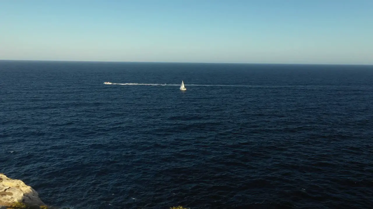 moving shot of a sailboat from the land