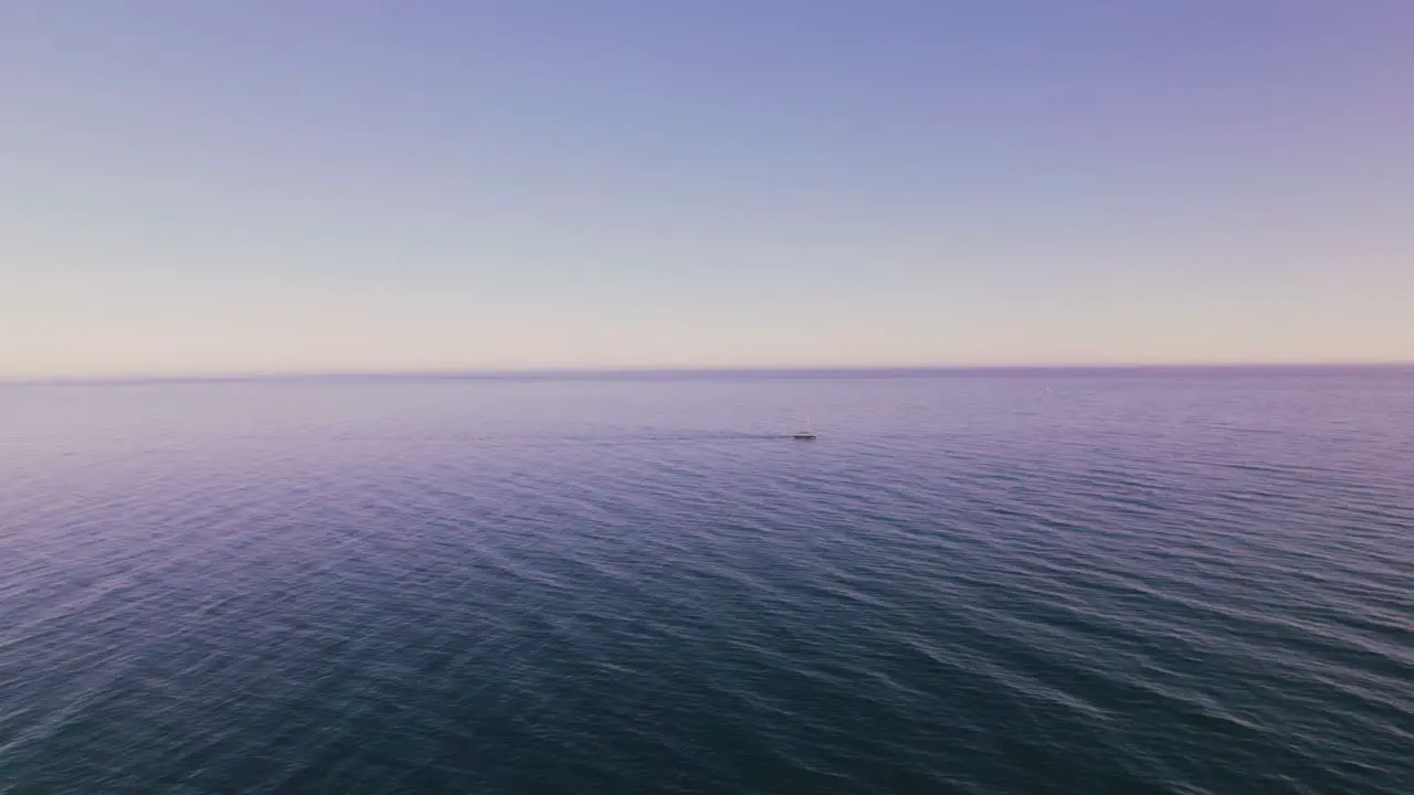 Yacht passing by the calm Mediterranean sea with a clear blue sky