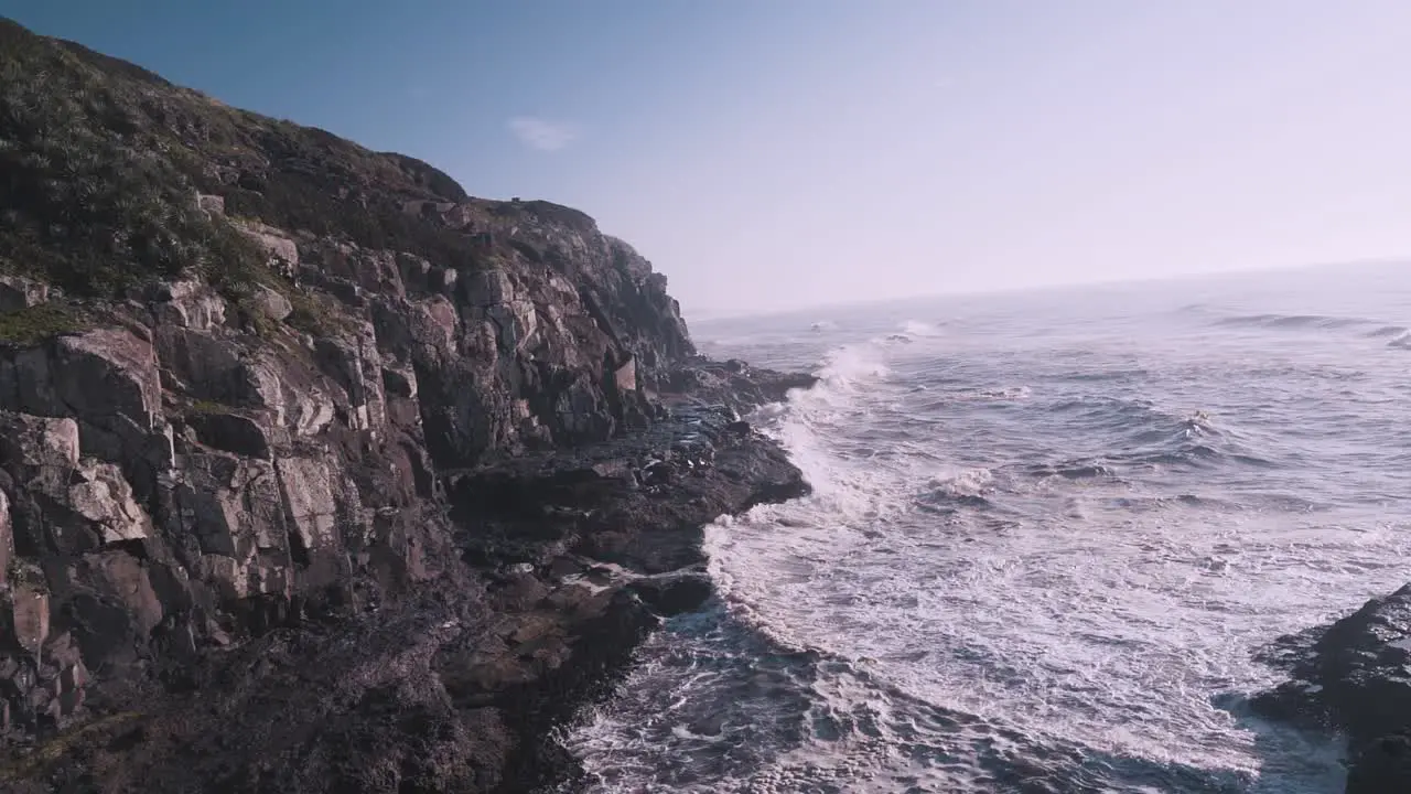 Waves crashing on cliffs of the atlantic ocean at sunrise