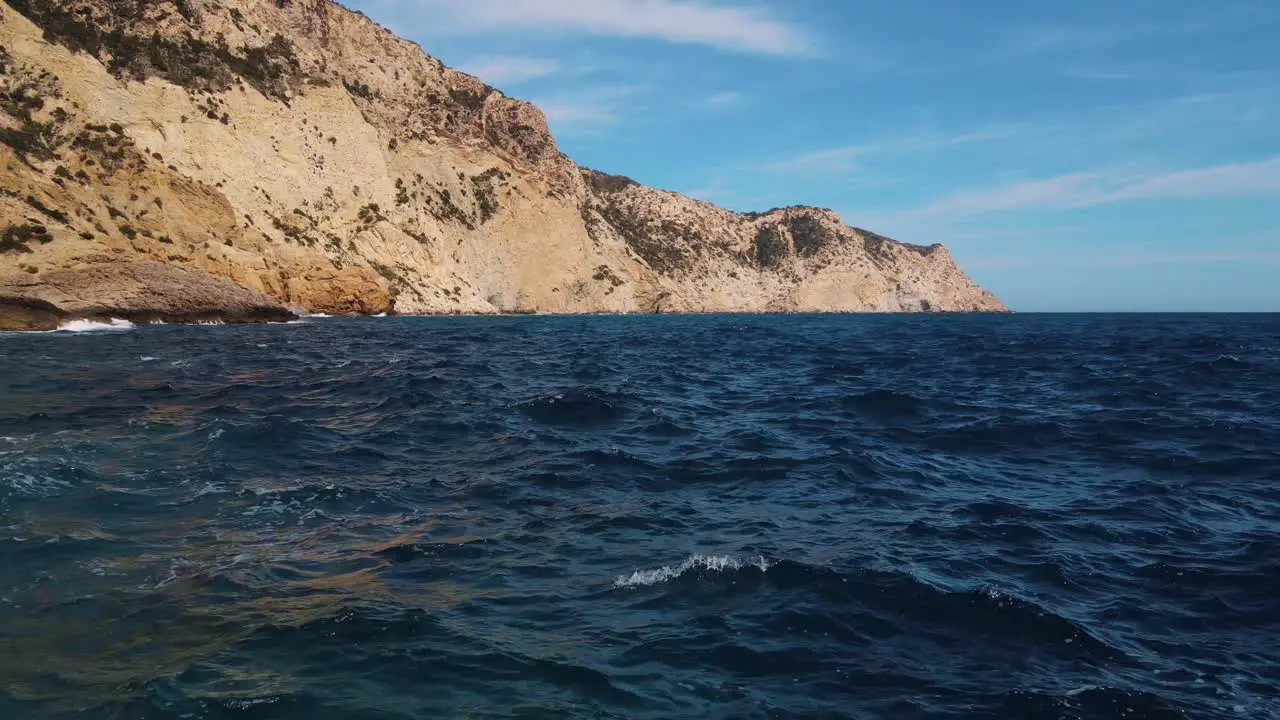 aerial over natural infinity pool over ocean at Sa Pedrera de Cala d'Hort Ibiza