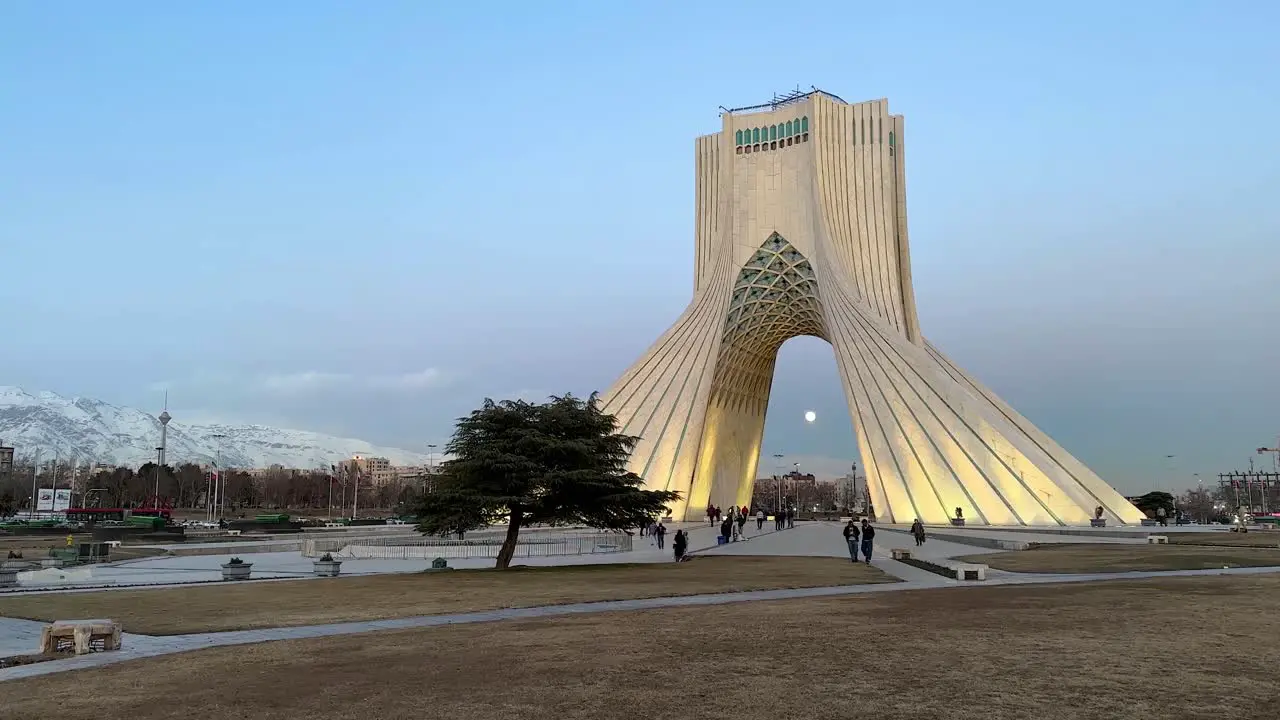 People Traveling to Iran Tehran the capital city of the country in middle east visit iconic landmark minimal landscape tourist attraction in city center downtown Azadi square Shahyad tower museum art