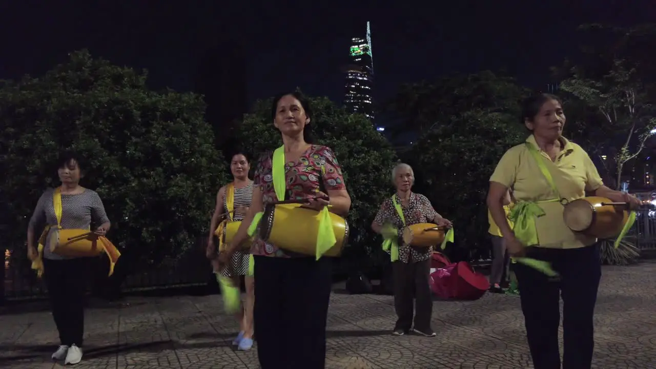 A group of women dance and play drums to celebrate the moon festival or Mid Autumn Festival in Ho Chi Minh City aka Saigon Vietnam