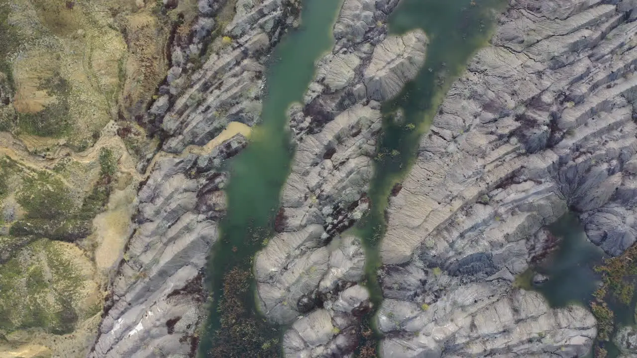 Beautiful rock pattern in between small lakes of green water