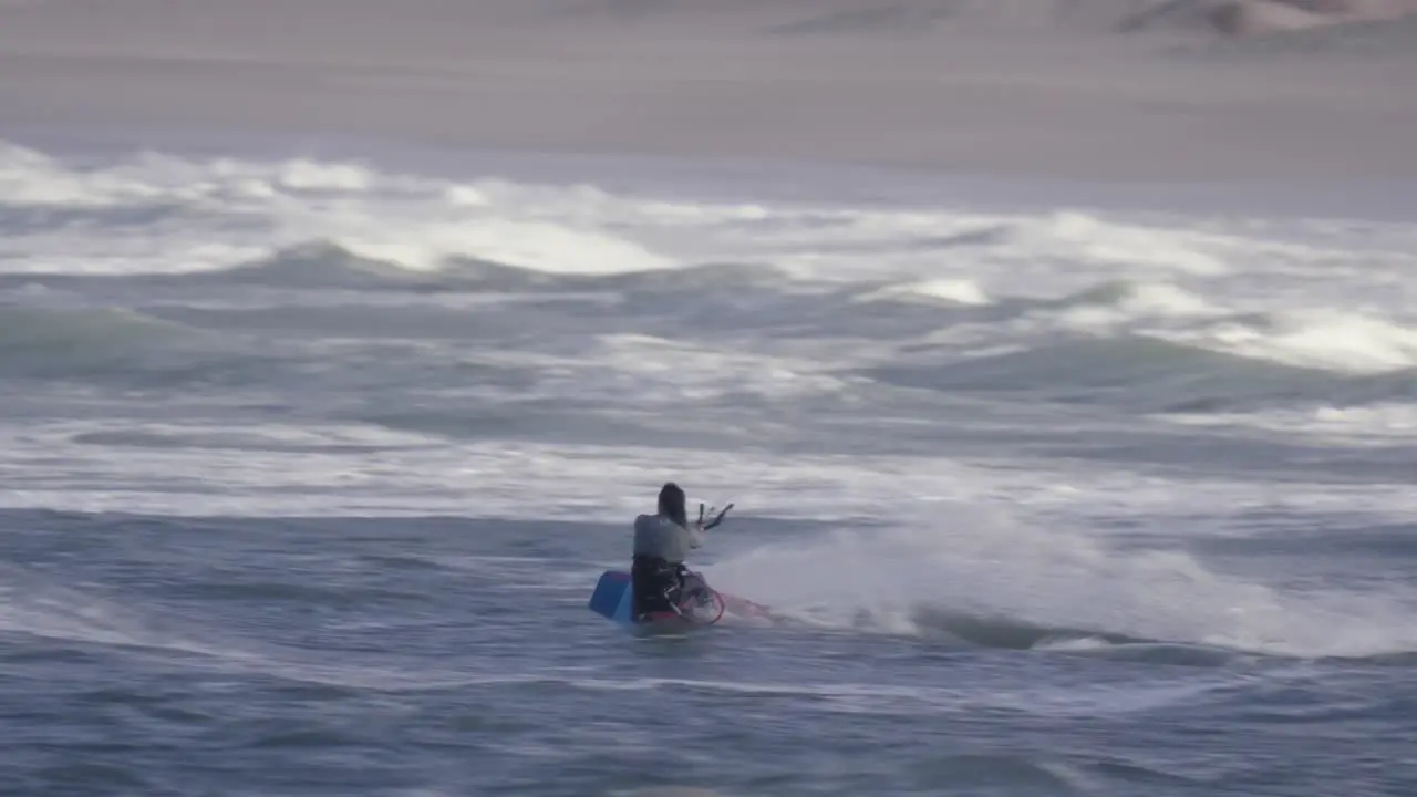 Fast kiteboarder jumping on big ocean waves adrenaline water sport