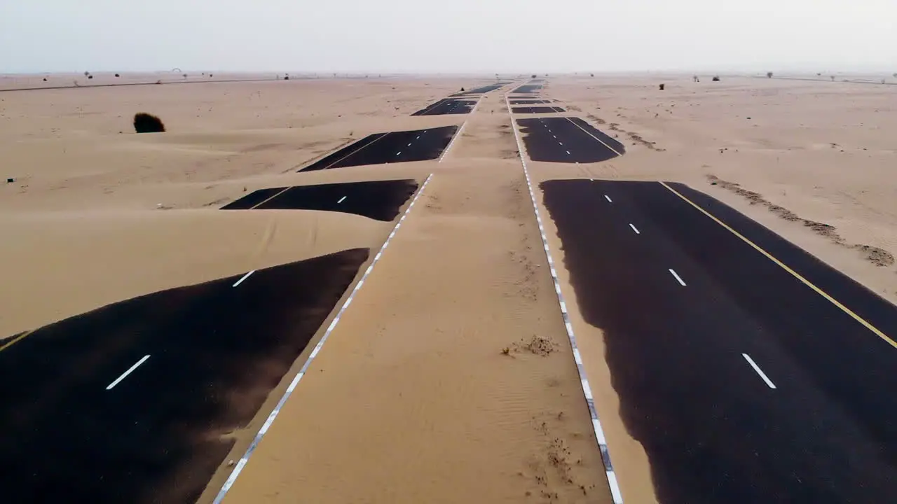 Aerial view of abandoned post apocalyptic roads covered in sand dunes