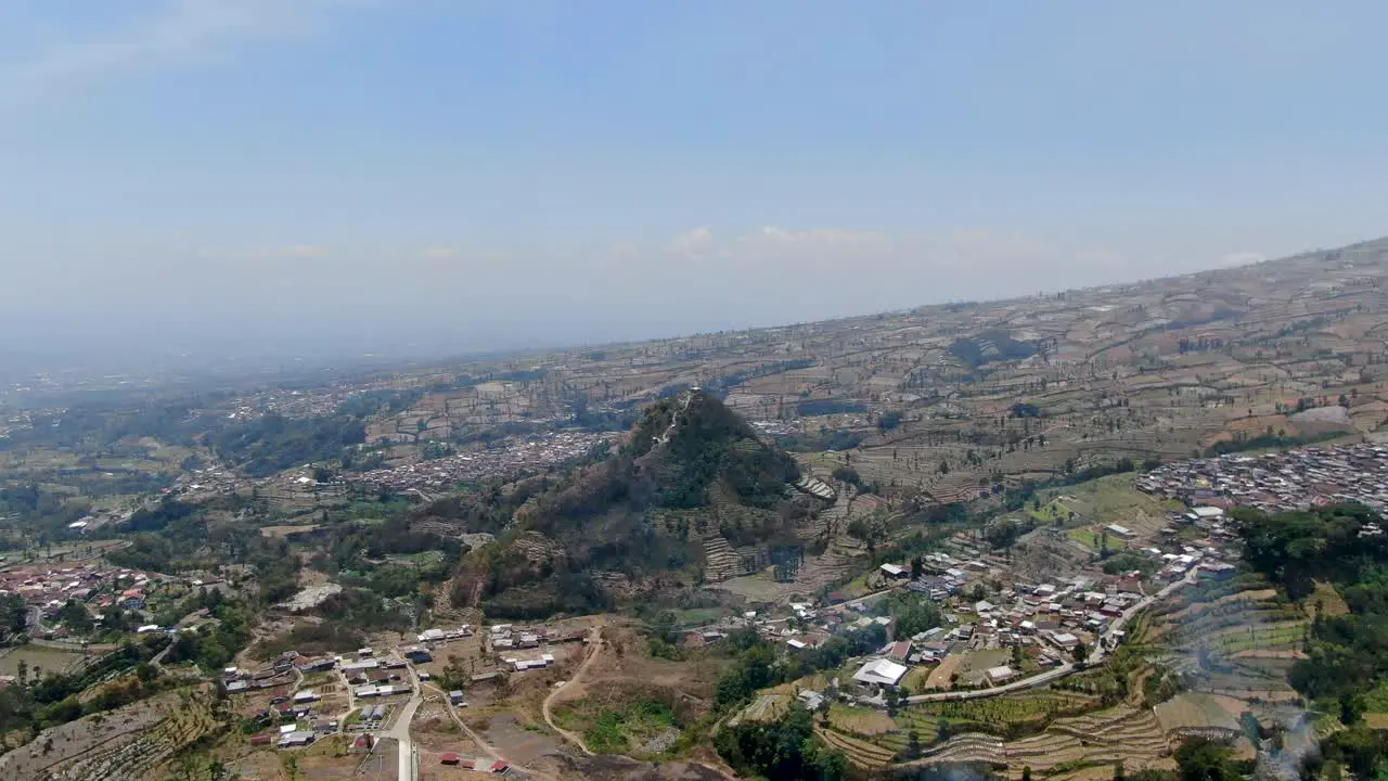 Many village on mountain base during dry season aerial drone view