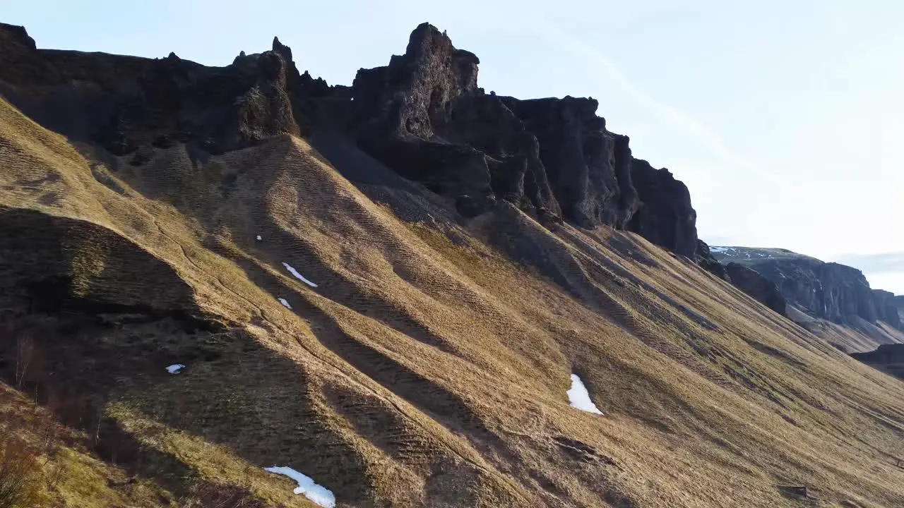 Sunlit mountain range against sky