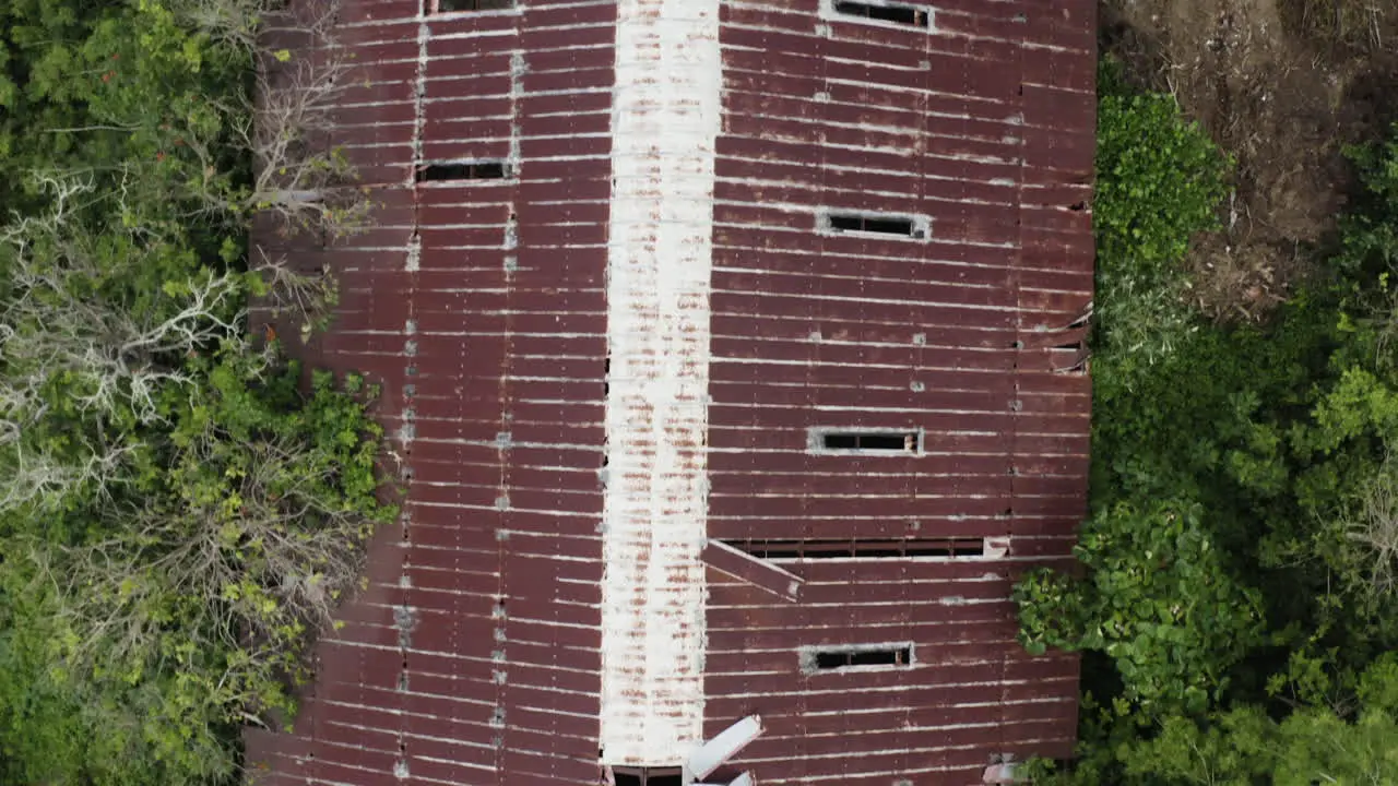 Aerial drone footage of an old and now rusty collapsing warehouse in Puerto Rico