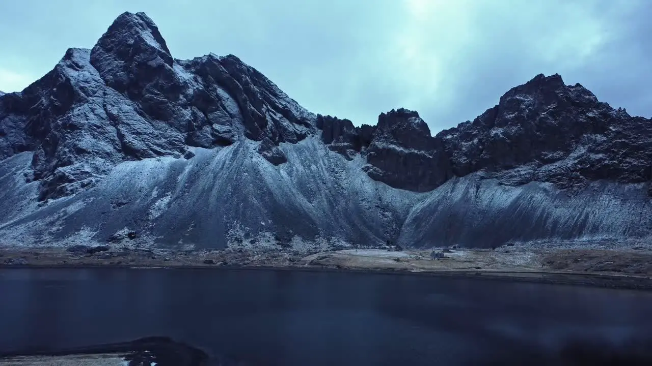 Snowy mountains against cloudy sky