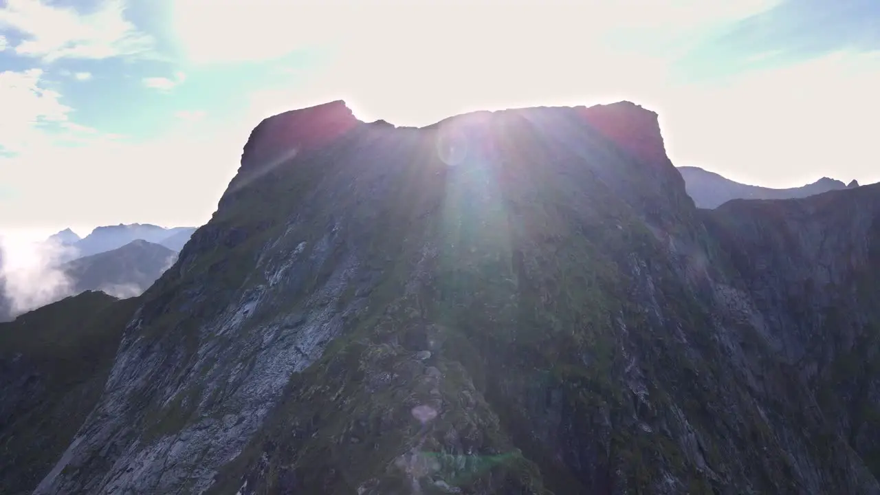 Flying towards a flat mountain peak in Norway at sunrise