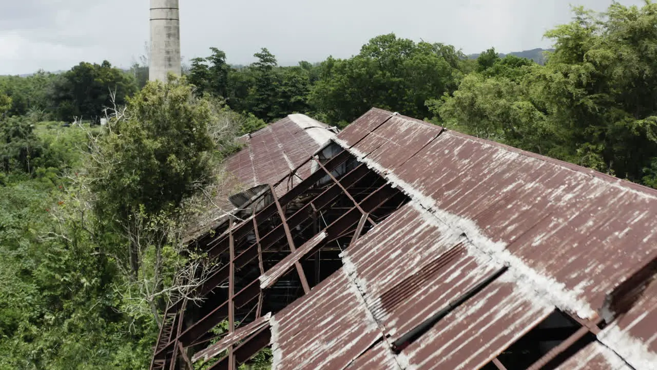 Smooth cinematic crane up past the old abandoned rust factory in Los Canos Puerto Rico