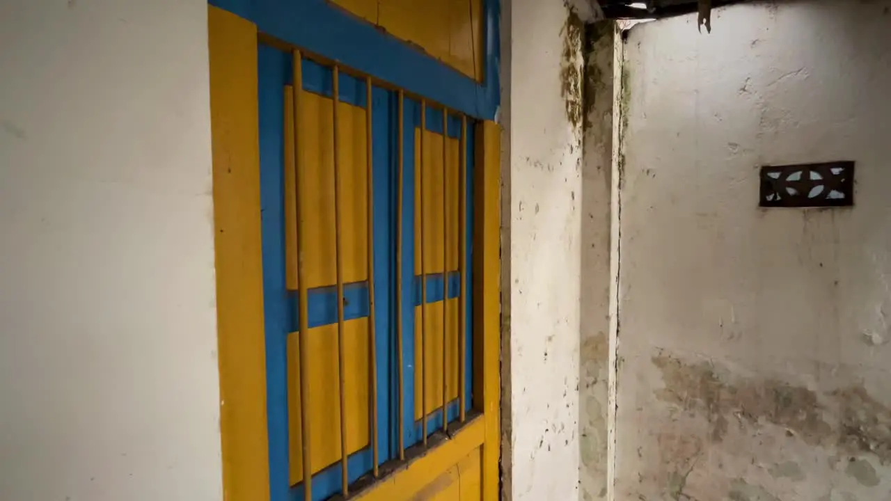 Wooden window with iron bars on old house