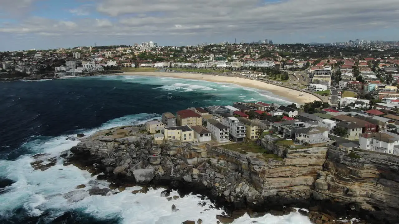 Stormy ocean with Ben Buckler Point and Bondi Beach in background