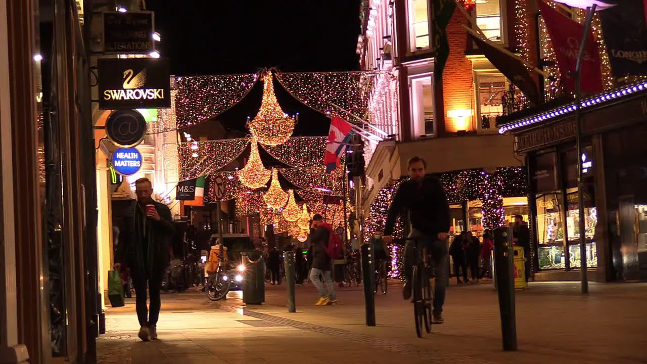 Still shot of a Dublin street at Chrismas time in hard times with some people on a not so busy street and business closed