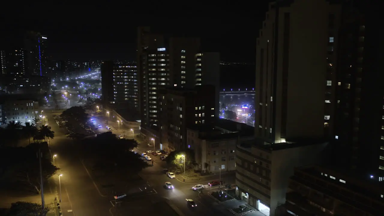 Aerial drone shot of Durban city centre at night with cars on the roads