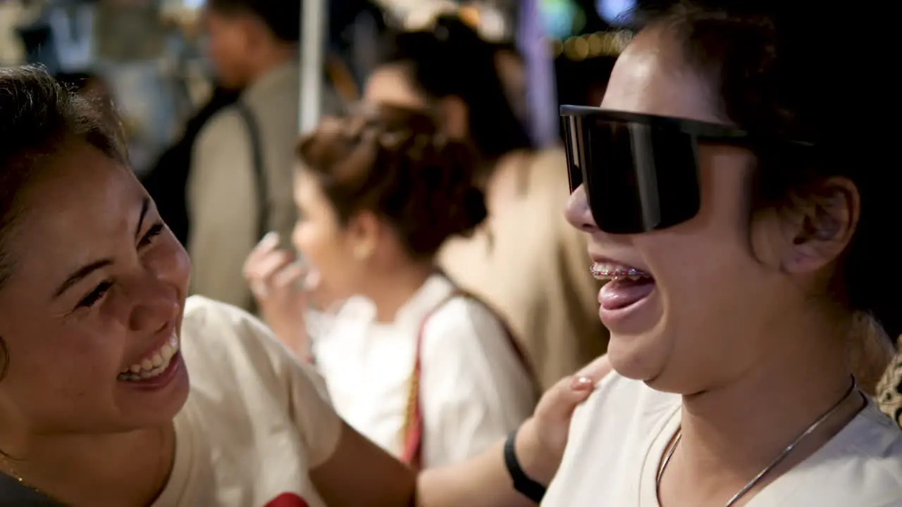 young woman trying on sunglasses laughing