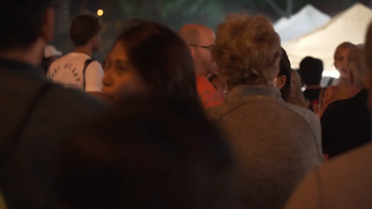 Hawaiian Busy Market street with tourists enjoying the night time in Oahu Island Static Close up shot