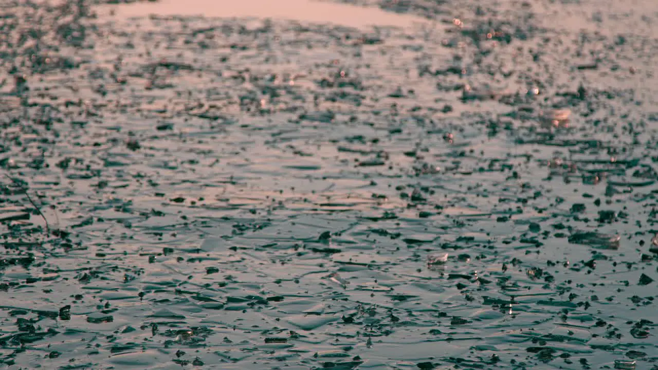 Melting frozen ice on lake frozen ice waves shelf that has partially melted view during golden hour