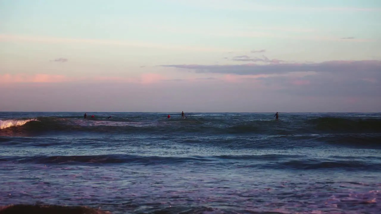 Ocean waves and surfers at the sea in slow motion