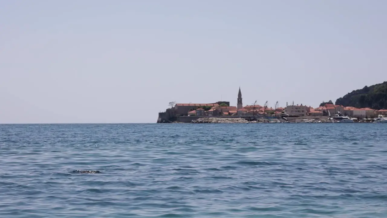 Scuba diver in the sea in the background the Old Town