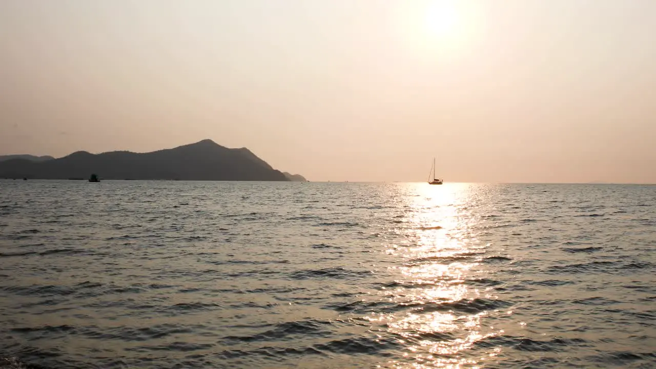 Scenic View of a Sunset with a Yacht on the Horizon During a Beautiful Sunset in Bangsaray near Pattaya Thailand