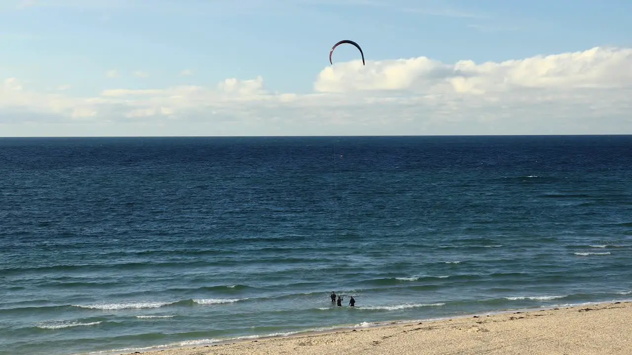 Surfers Performing Sea Activities On Tropical Hayle Beach In Cornwall England