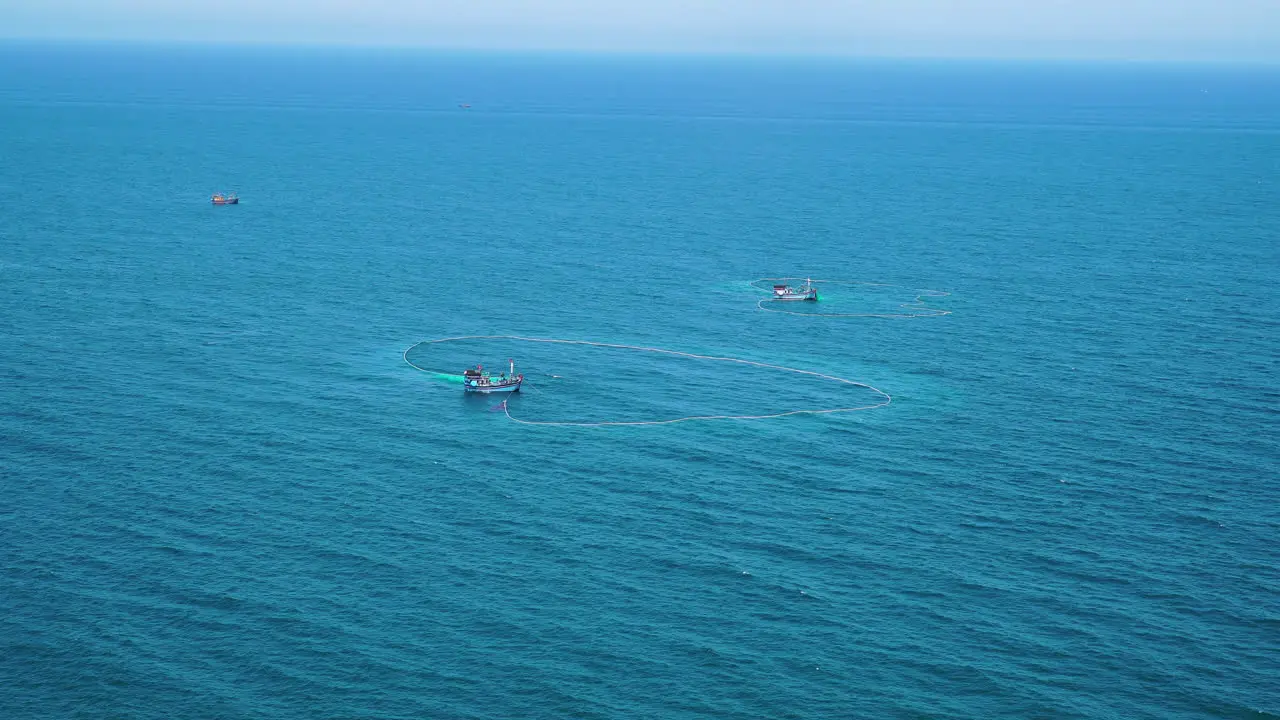 Two fishing boats catch fish on coast of Vietnam zoom in