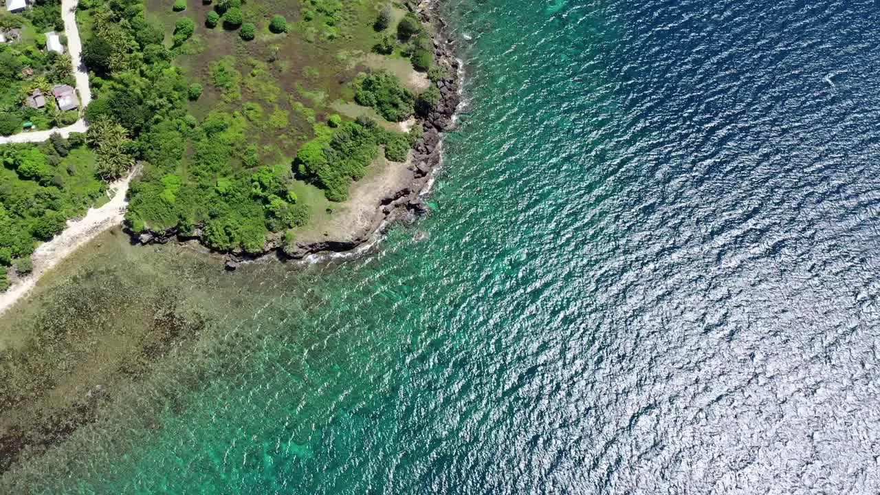 Aerial bird's eye view above a tropical coastline with turquoise water