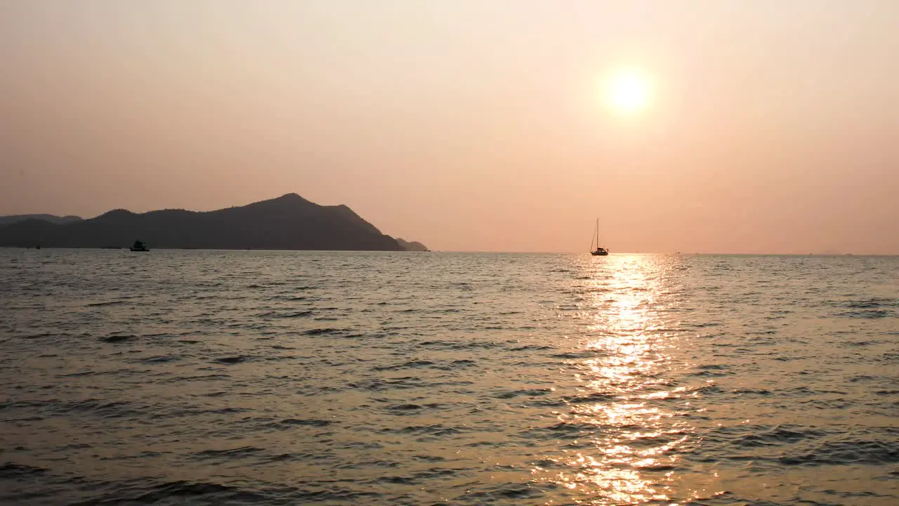 Stunning Sunset Over Calm Waters with a Yacht on the Horizon in Bangsaray near Pattaya Thailand