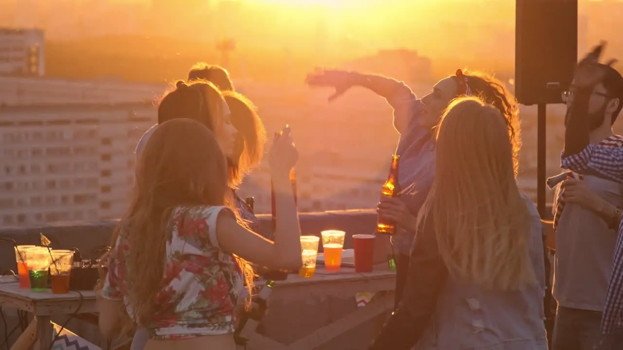 Group Of Friends Enjoying A Party On A Terrace At Sunset 2