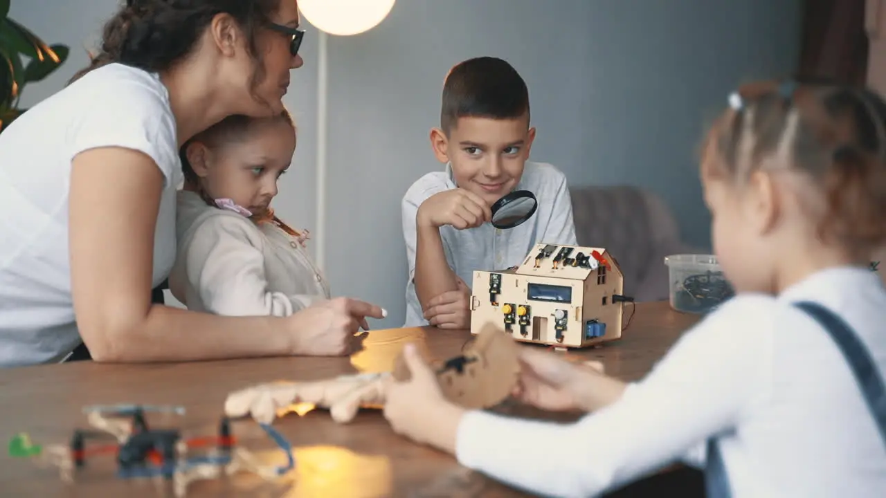 Female Teacher Helps Little Boy And Girls Interested In Science And Technology To Build Robots