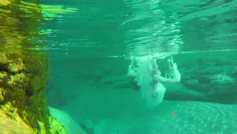 Woman in a red bikini swimming underwater