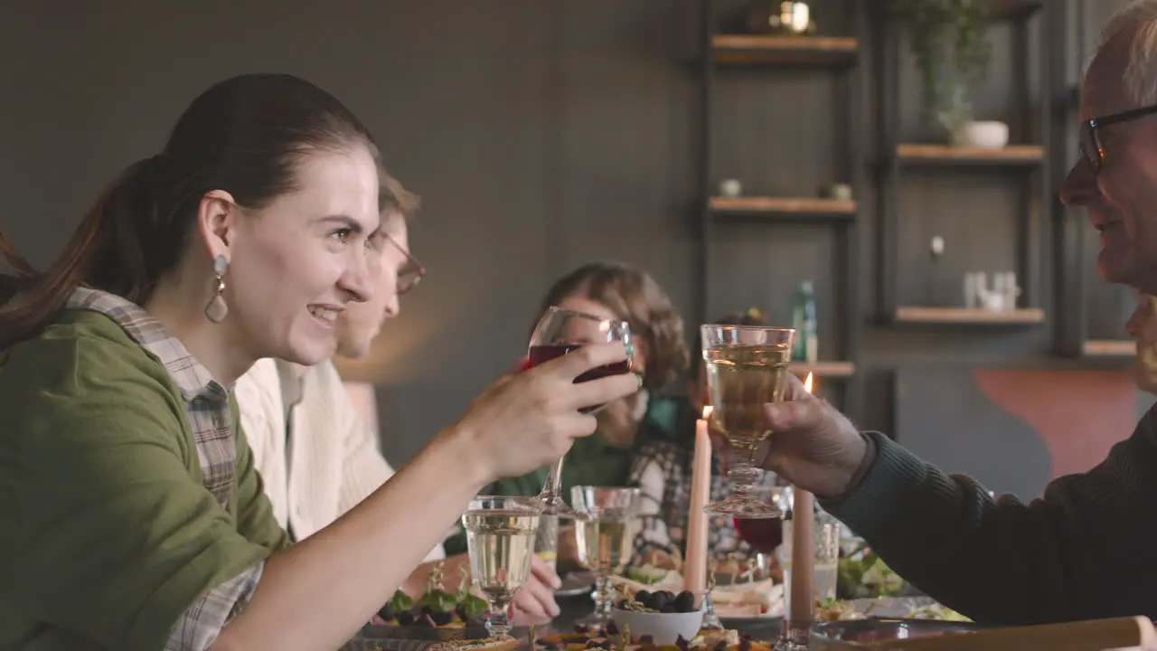 Happy Family Sitting At Table And Having A Meal At Home