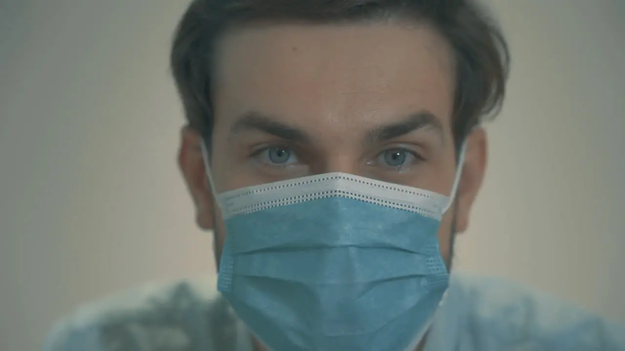 Close Up Portrait Of Young Handsome Man With Blue Eyes Wearing A Face Mask And Looking At Camera