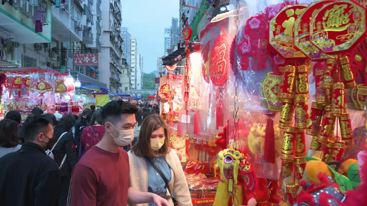 People buy Chinese New Year decorative ornaments goods at a street market during the preparation for the Chinese New Year celebration and festivities