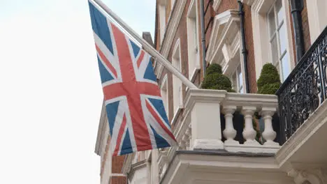 Close Up Of Union Jack Flag Flying On Building In Grosvenor Street Mayfair London