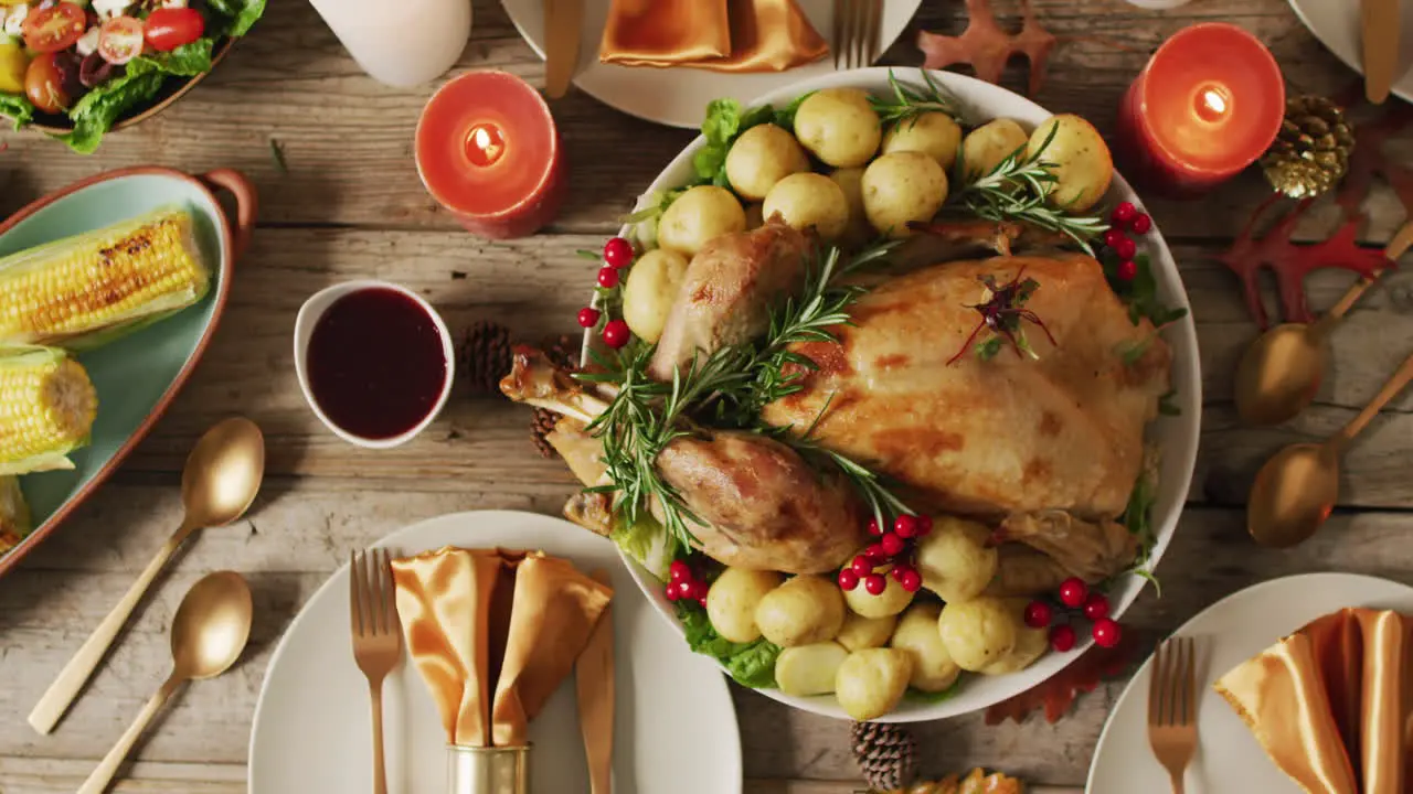 Video of tray with roasted turkey and diverse dishes on wooden surface