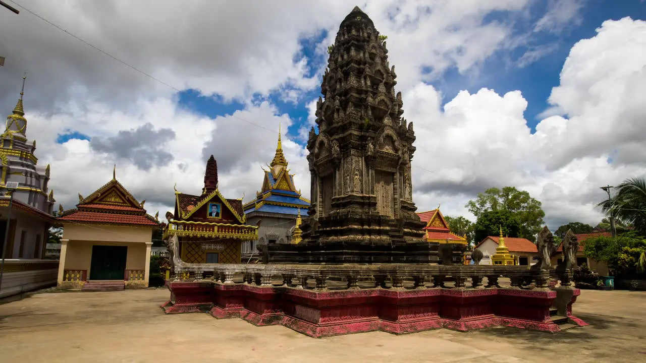 Angkorian like temple structure in pagoda a place of worship during fluffy monsoon clouds building on blue sky