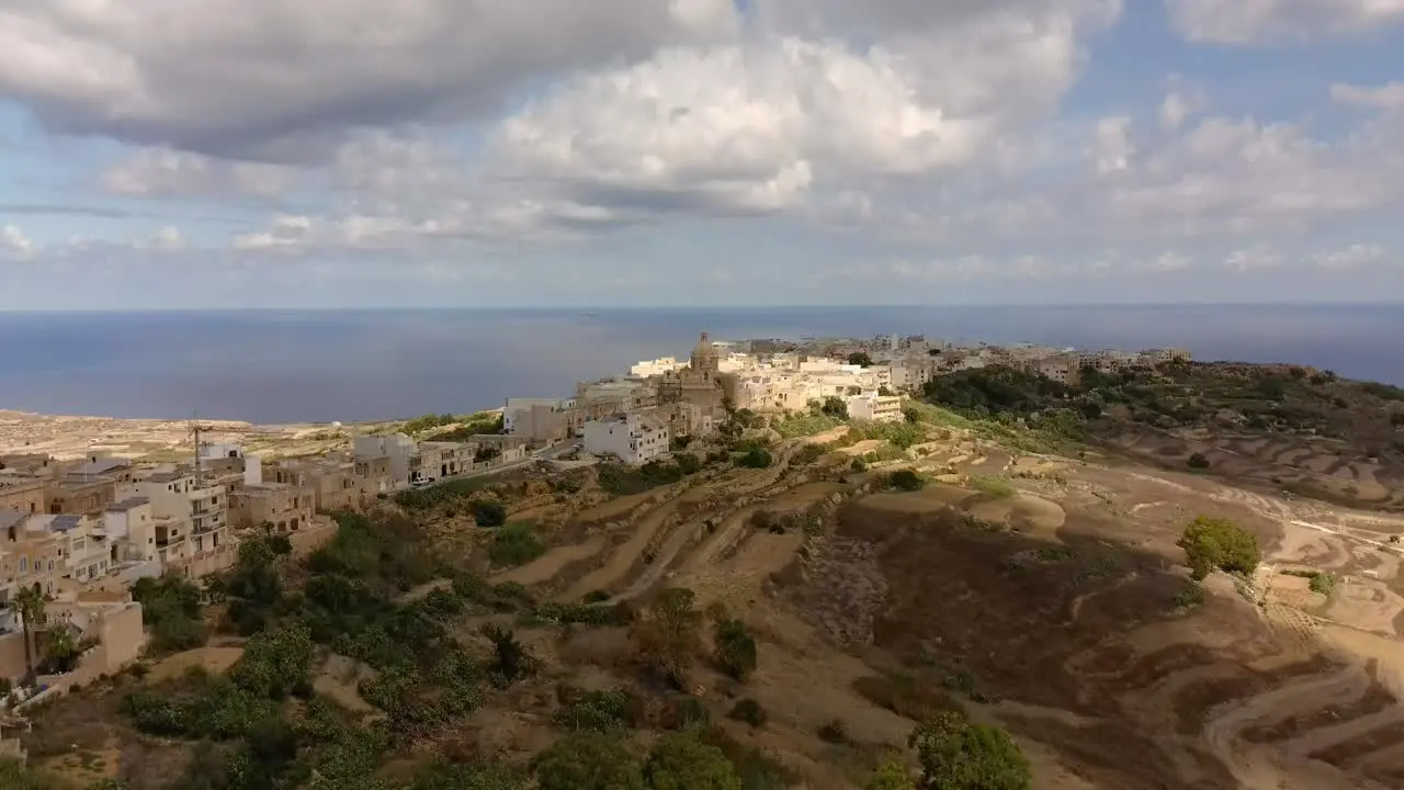 Drone shot pedestal up to a view of Xewkija village in Gozo