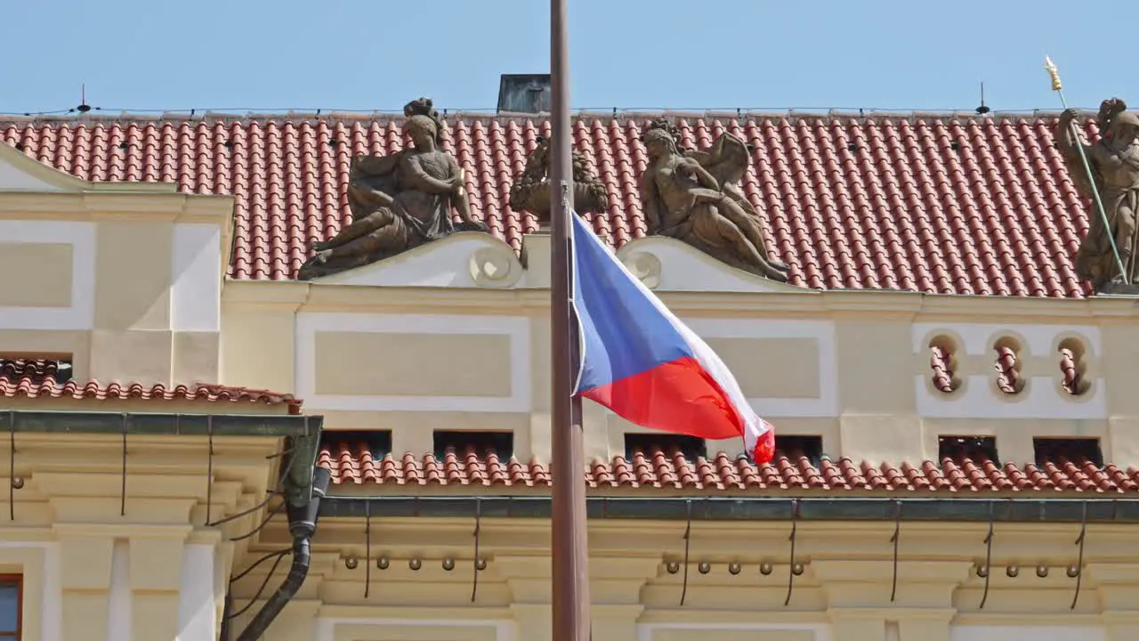 the Czech flag waving in slow motion against the backdrop of the Royal Castle in Prague