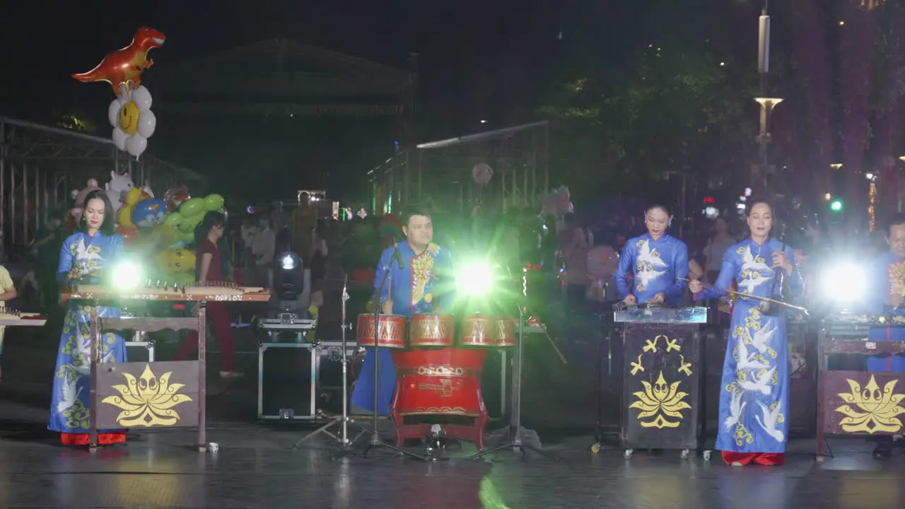 Traditional Vietnamese folk music group performs on stage in Ho Chi Minh city at night