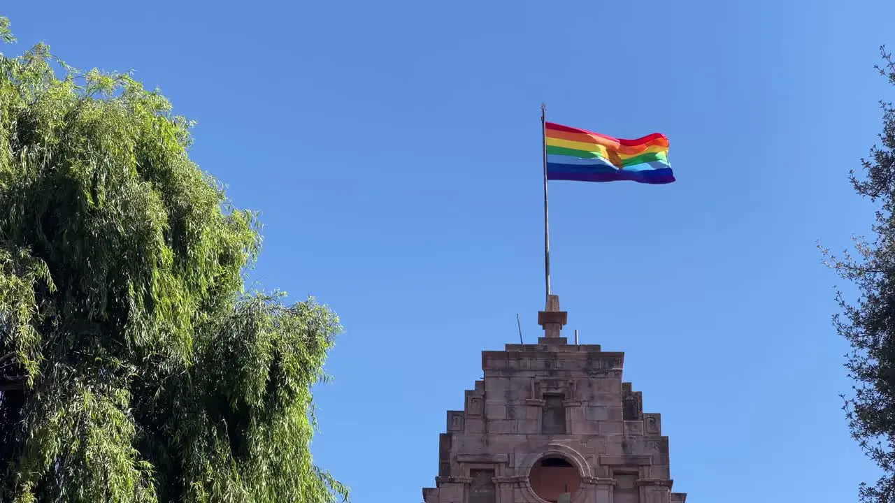 The Inka Rainbow flag blows in the wind on a summer day in Cusco Peru