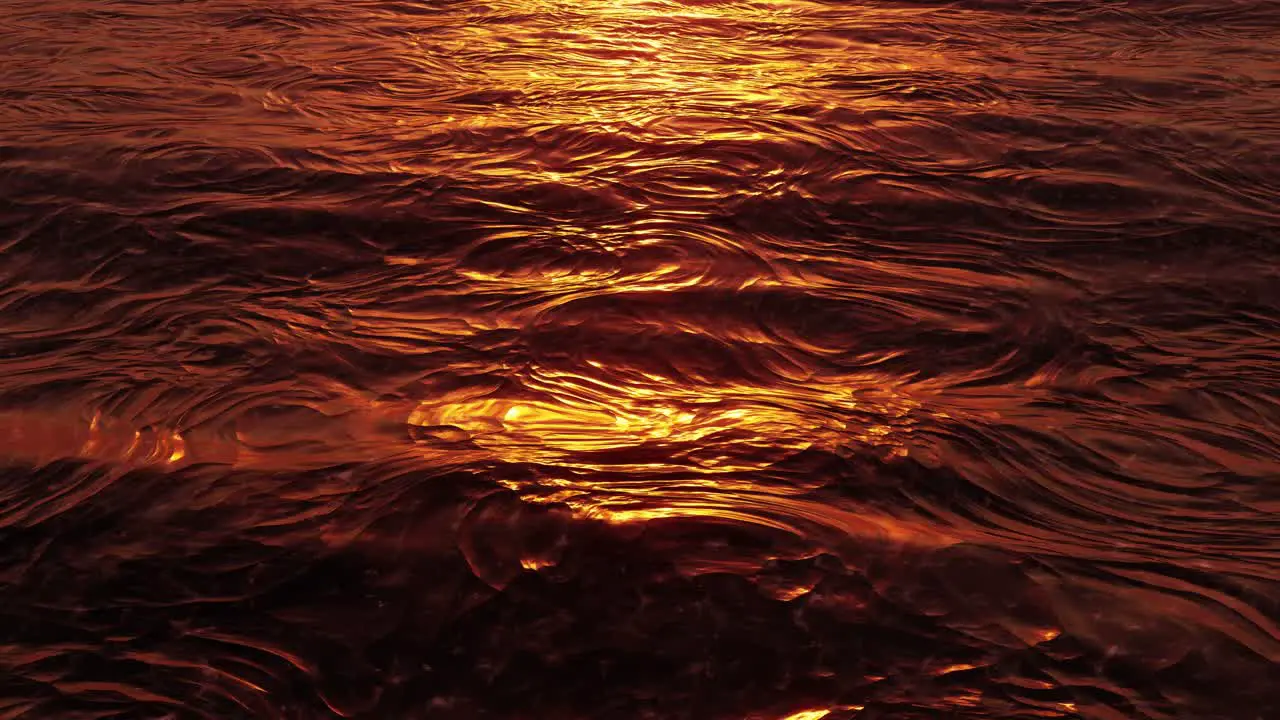 Gentle calm and tranquil ocean waves rolling by at golden hour orange sunset seamless looping