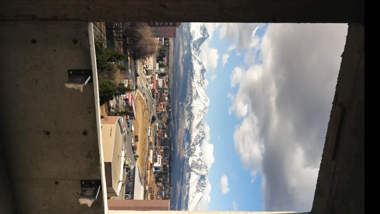 Industrial construction window mountains and city vertical time lapse sunny weather